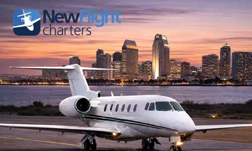 Private jet at San Diego International Airport with harbor and city skyline during annual private jet travel planning